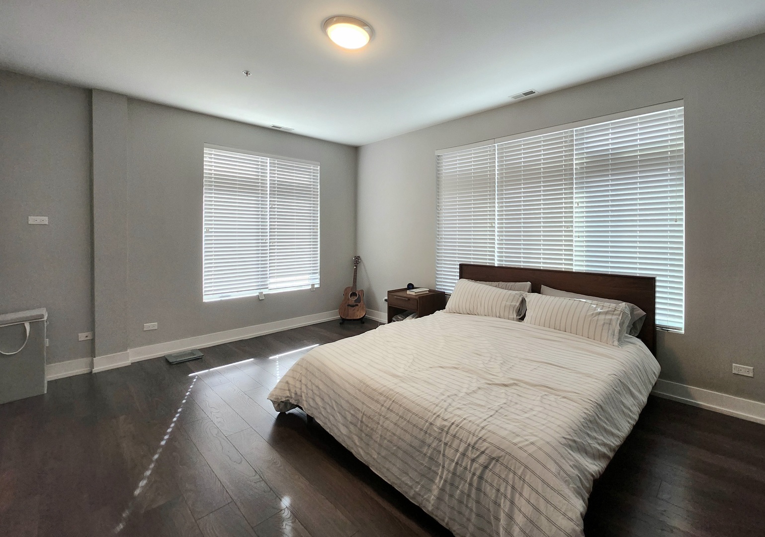 1202 Waukegan Road, Unit 201 Glenview, IL 60025 - Photo 9 of 15 a bedroom with a bed and wooden floor