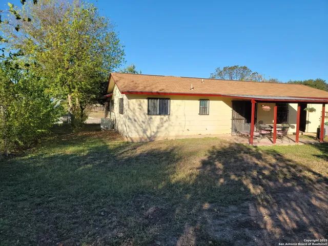 a view of a white house with a yard