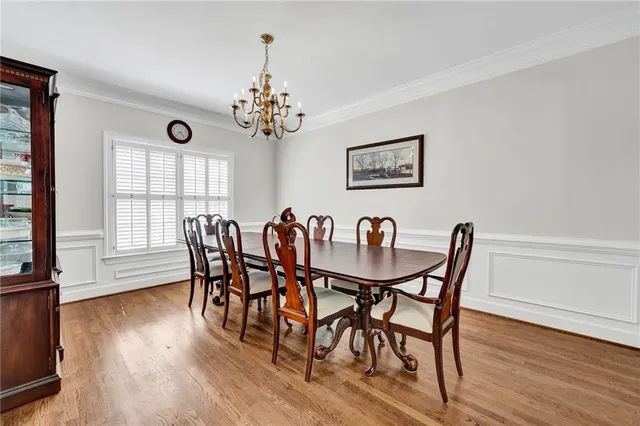 a view of a dining room with furniture wooden floor and chandelier
