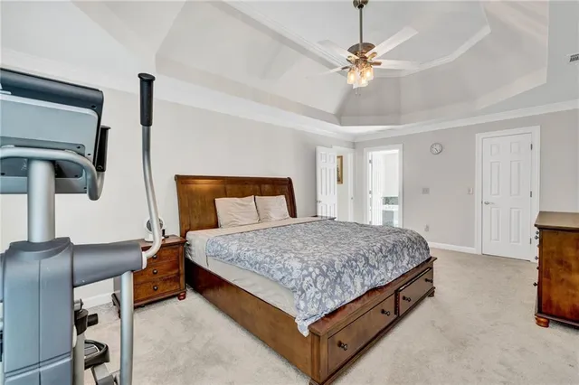 a bedroom with a bed and dresser with mirror