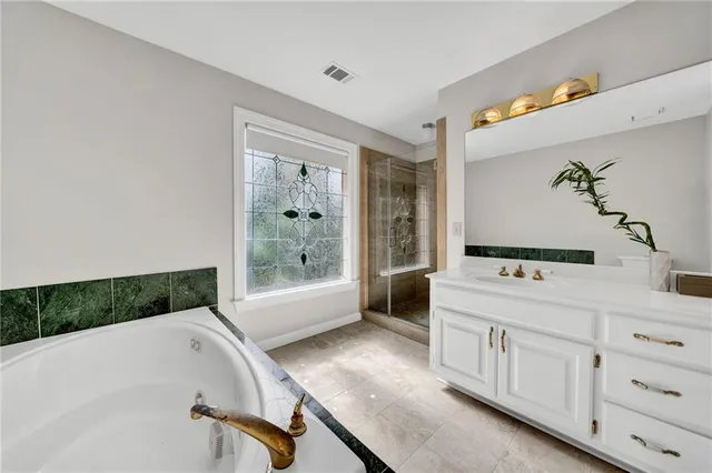 a bathroom with a bathtub and a shower