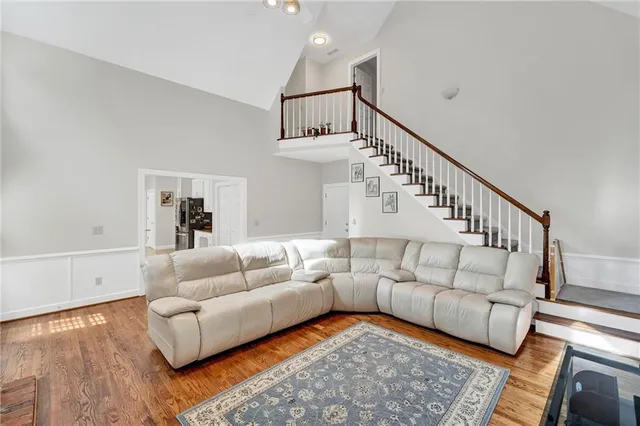 a kitchen with stainless steel appliances granite countertop a table chairs and a refrigerator