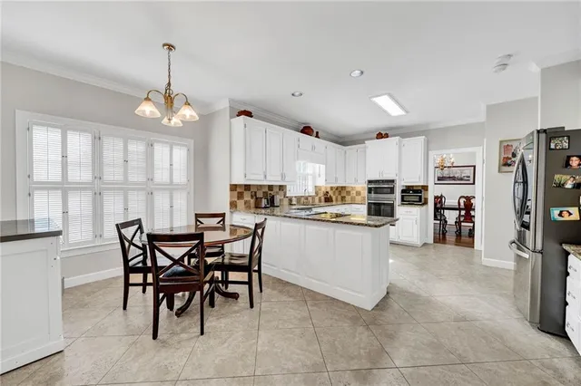 a kitchen with stainless steel appliances granite countertop a refrigerator sink and cabinets