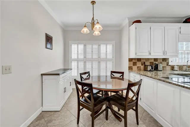 a kitchen with white cabinets and appliances