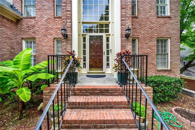 a view of a house with potted plants