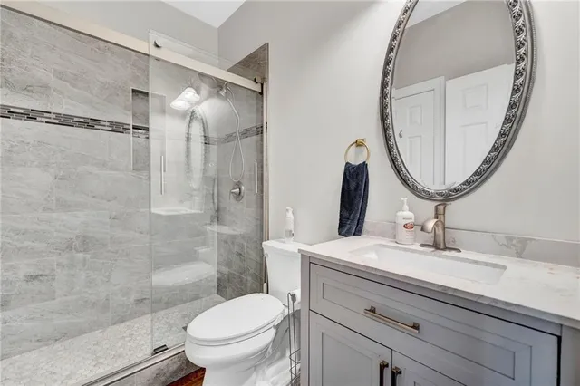 a bathroom with a sink toilet and a mirror