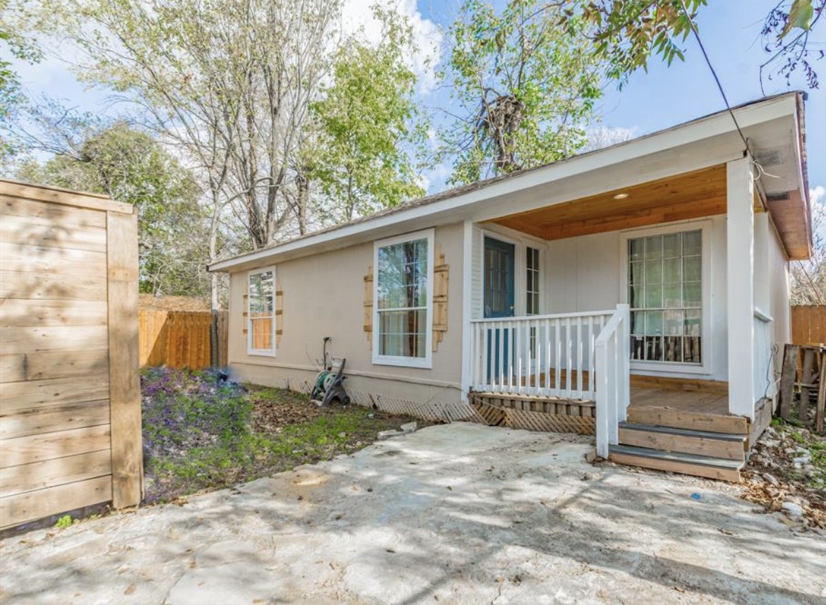 a backyard of a house with table and chairs