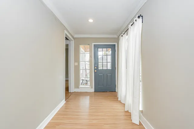 a view of a kitchen with wooden floor and a ceiling fan