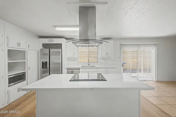 a kitchen with a sink and a refrigerator