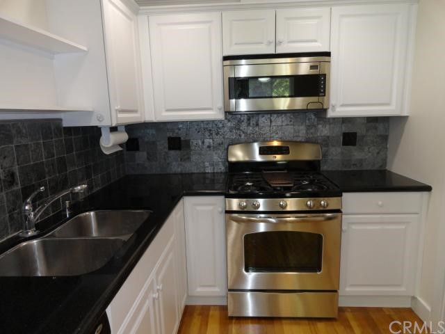 8115 Redlands Street, Unit 107 Playa del Rey, CA 90293 - Photo 1 of 1 New appliances and black granite counters. Kitchen features walk in pantry and laundry in the closet.