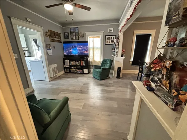 a living room with furniture and a chandelier