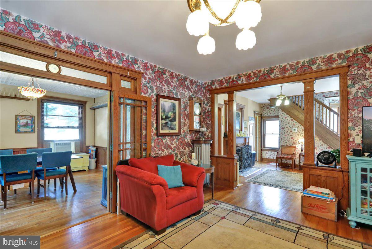 207 State Street Reading, PA 19607 - Photo 13 of 55 a living room with furniture a chandelier and a dining table