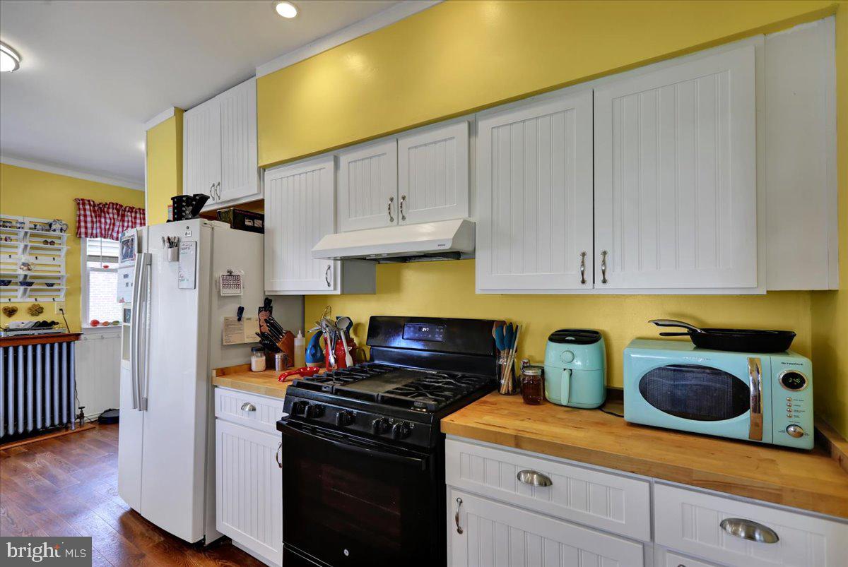 207 State Street Reading, PA 19607 - Photo 16 of 55 a kitchen with stainless steel appliances granite countertop a refrigerator a stove and a cabinets