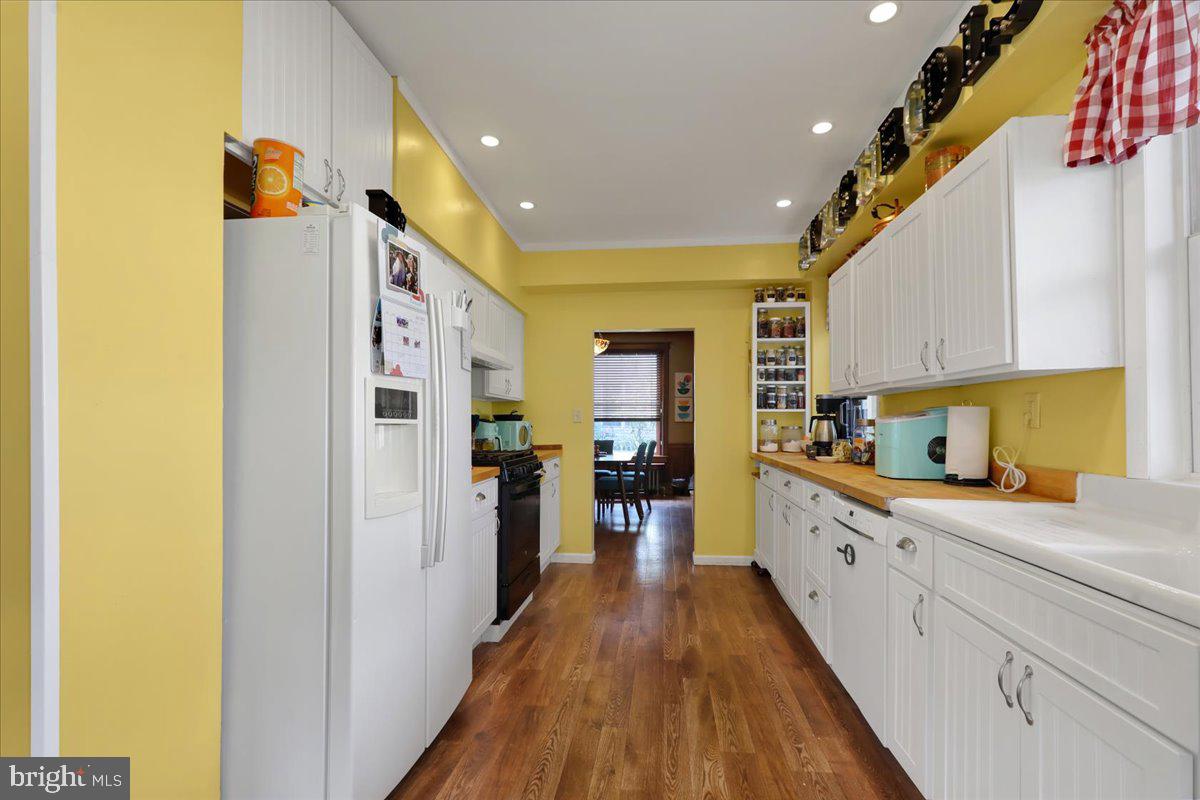 207 State Street Reading, PA 19607 - Photo 18 of 55 a kitchen with cabinets and wooden floor
