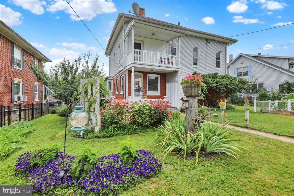 207 State Street Reading, PA 19607 - Photo 49 of 55 a front view of a house with a yard and potted plants