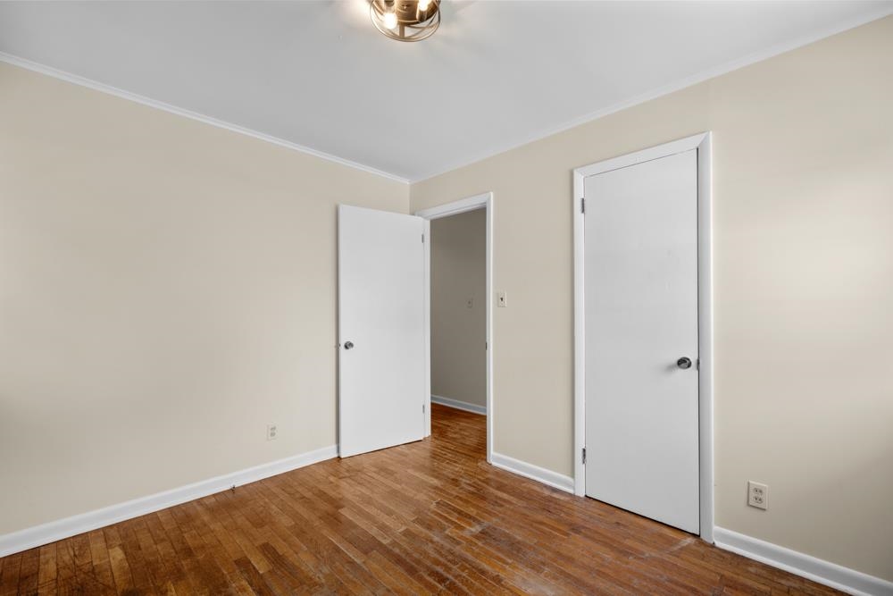 211 Drake Avenue Ripley, TN 38063 - Photo 21 of 25 a view of an empty room with wooden floor and a window