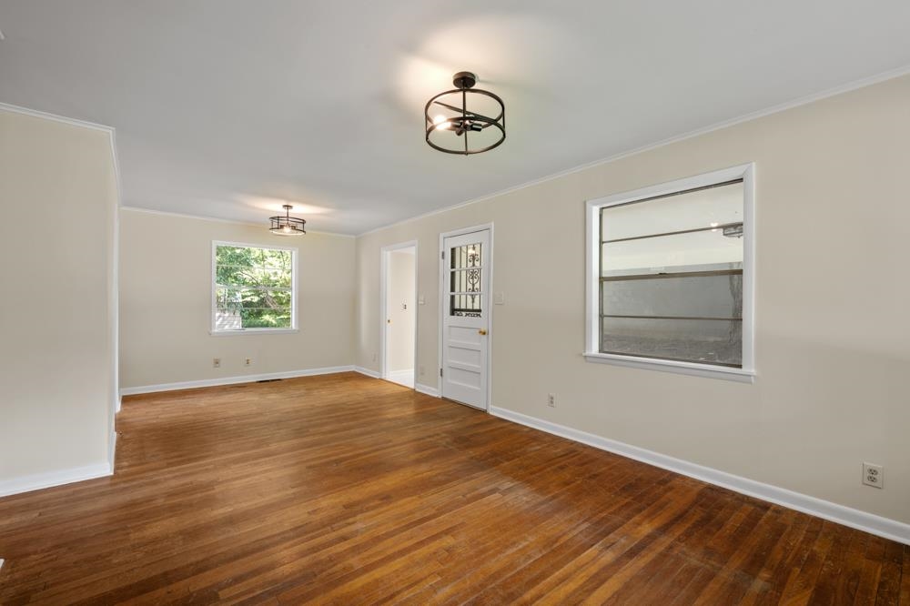 211 Drake Avenue Ripley, TN 38063 - Photo 5 of 25 a view of empty room with window and wooden floor