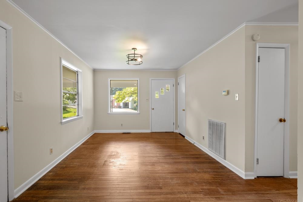 211 Drake Avenue Ripley, TN 38063 - Photo 6 of 25 an empty room with windows and entrance