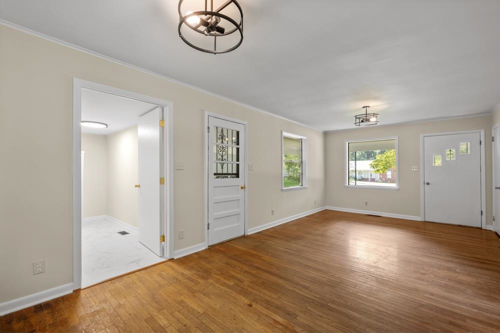 211 Drake Avenue Ripley, TN 38063 - Photo 8 of 25 an empty room with wooden floor closet and windows