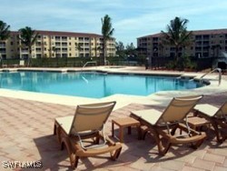 8490 Kingbird Loop, Unit 942 Estero, FL 33967 - Photo 3 of 11 a view of a lake with table and chairs