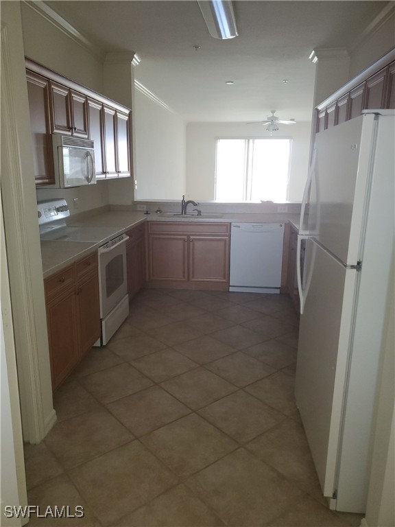 8490 Kingbird Loop, Unit 942 Estero, FL 33967 - Photo 10 of 11 a kitchen with a refrigerator sink and cabinets