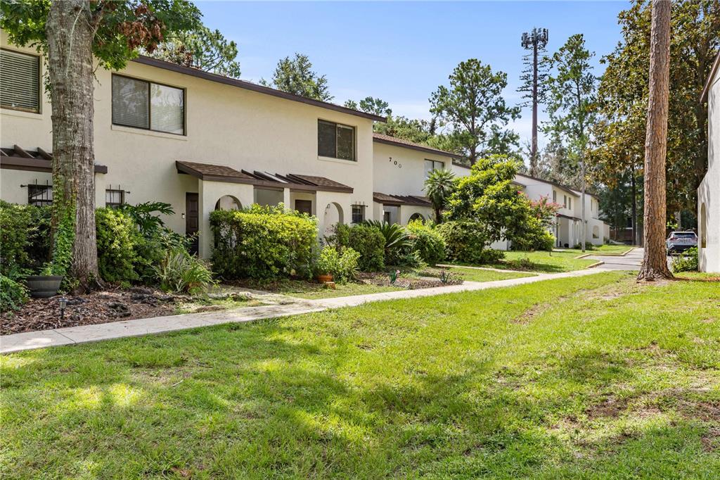 2635 Southwest 35th Place, Unit 705 Gainesville, FL 32608 - Photo 1 of 23 a front view of a house with garden
