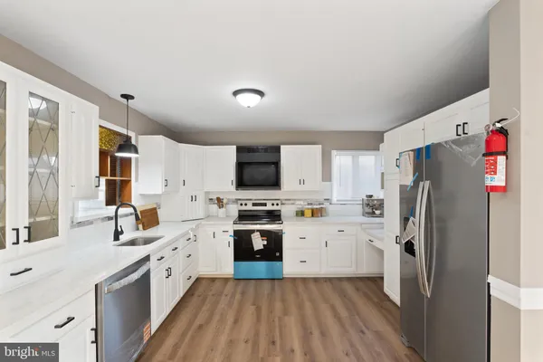a kitchen with stainless steel appliances a refrigerator sink and stove