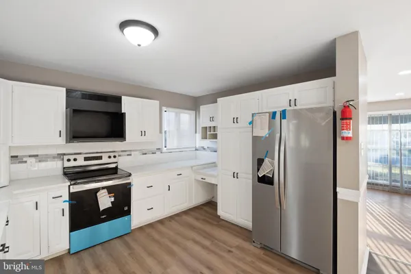 a kitchen with stainless steel appliances a refrigerator stove and sink