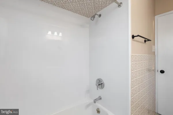 a bathroom with a bathtub and shower