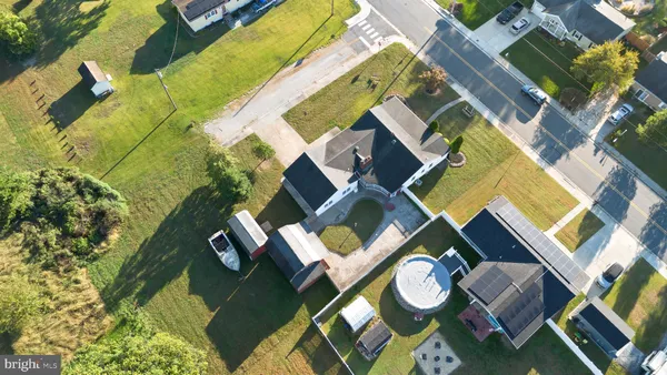 an aerial view of a house with a swimming pool and outdoor space