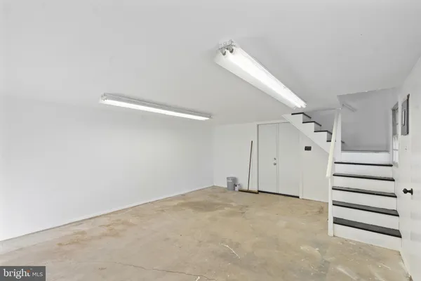 a view of a room with stairs and a closet