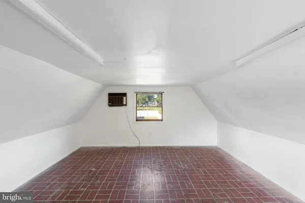 an empty room with a empty space and windows