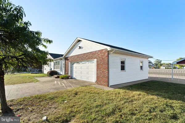 a backyard of a house with yard and wooden fence