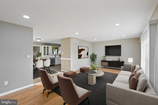 a living room with furniture a rug and a flat screen tv