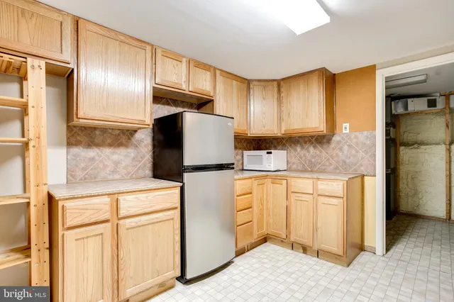 a kitchen with stainless steel appliances granite countertop a refrigerator and a stove