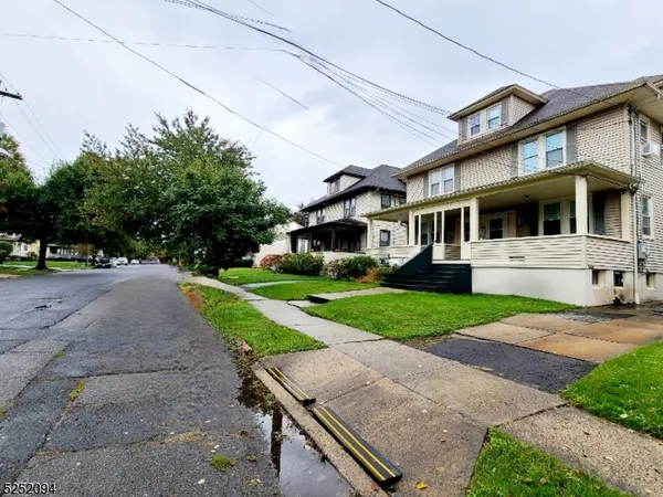 a front view of a house with a yard table and chairs