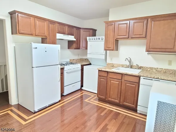 a kitchen with a refrigerator sink stove and cabinets