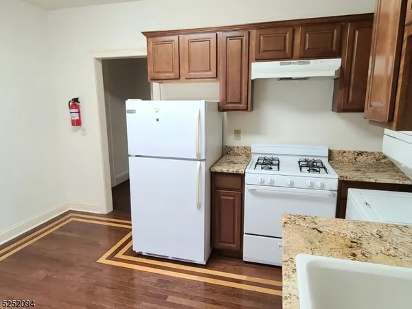 a kitchen with a refrigerator and a stove