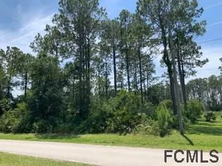 a view of a street with trees in the background