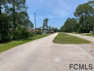 a view of a street with a play ground in front of the house