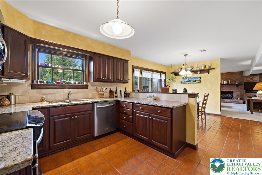 1700 Brandywine Road Allentown, PA 18104 - Photo 15 of 48 a kitchen with stainless steel appliances granite countertop wooden cabinets a sink dishwasher a stove and a refrigerator with wooden floor