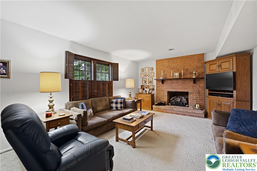 1700 Brandywine Road Allentown, PA 18104 - Photo 17 of 48 a living room with furniture a flat screen tv and a fireplace