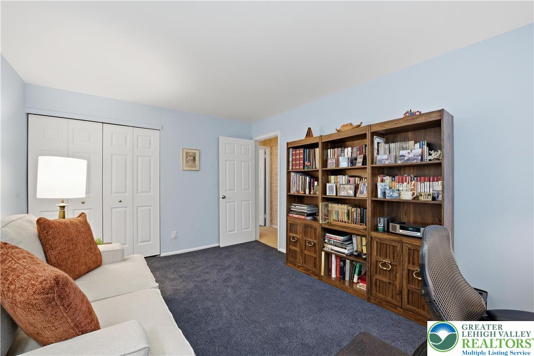 1700 Brandywine Road Allentown, PA 18104 - Photo 37 of 48 a living room with furniture a rug and a book shelf