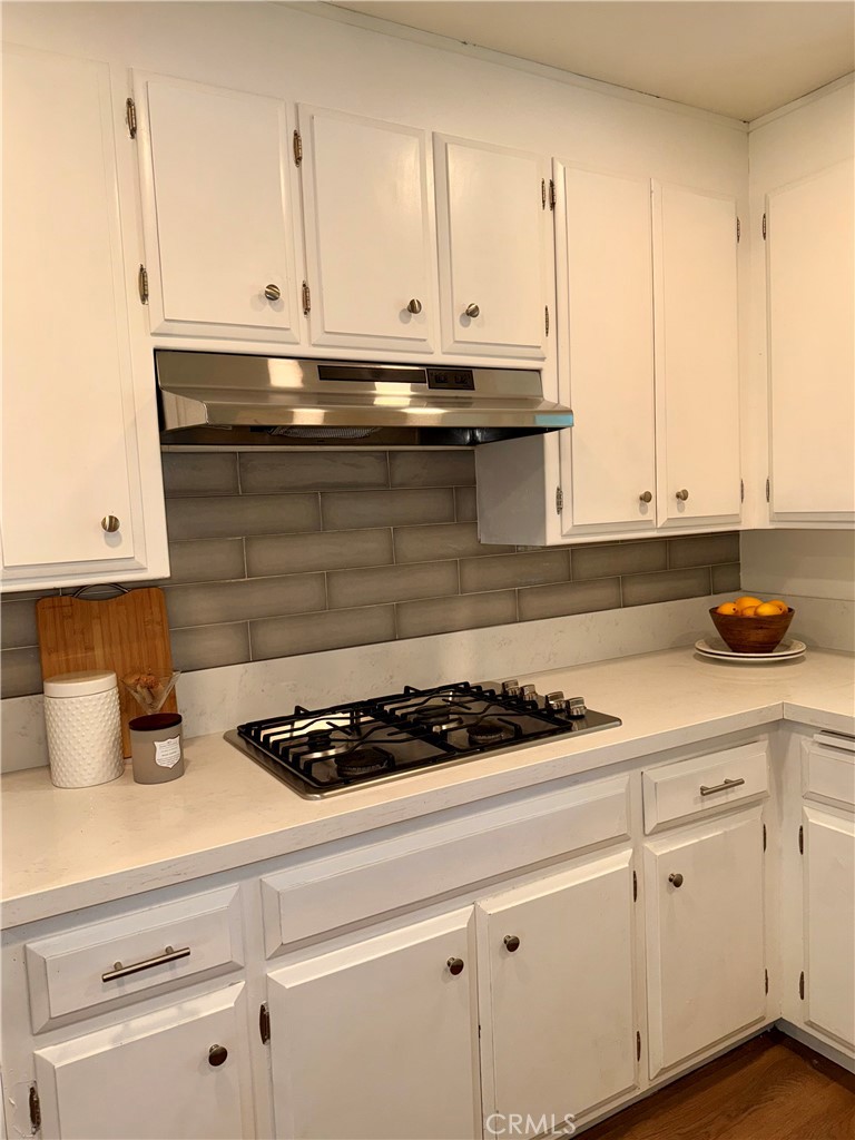 1094 Rey Circle Chico, CA 95926 - Photo 14 of 30 a kitchen with stainless steel appliances granite countertop a sink a stove and white cabinets