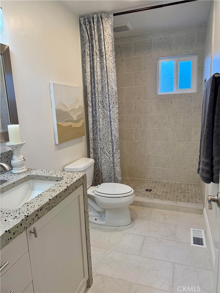1094 Rey Circle Chico, CA 95926 - Photo 21 of 30 a bathroom with a granite countertop sink toilet and shower
