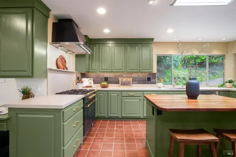 a kitchen with a sink and a stove top oven