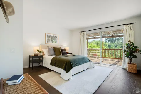 a spacious bedroom with a bed and a large window