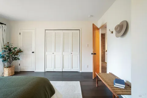 a bedroom with a bed and a potted plant