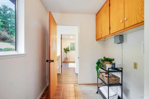 a hallway with table and flowerpot