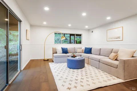 a living room with furniture a rug and a large window